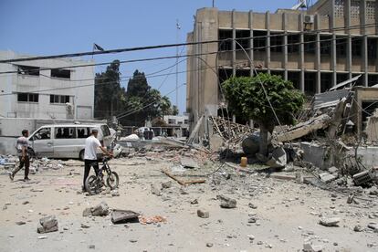 Varios palestinos se acercan a la sede de la UNRWA en Gaza para buscar víctimas entre los escombros del edificio bombardeado, el pasado junio.