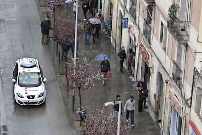 A police patrol car passes by prostitutes on the streets of Barcelona.