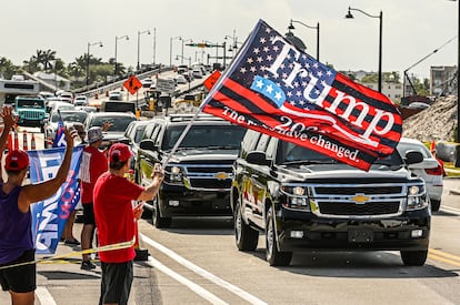 A motorcade, with former president Donald Trump on board, passes supporters in West Palm Beach, Florida, on April 1, 2023.