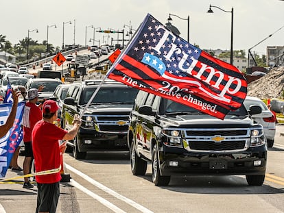 A motorcade, with former president Donald Trump on board, passes supporters in West Palm Beach, Florida, on April 1, 2023.