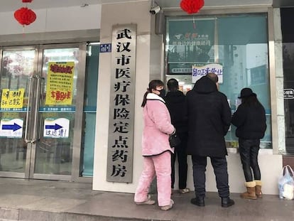 Ciudadanos hacen cola ante una farmacia en Wuhan, China.