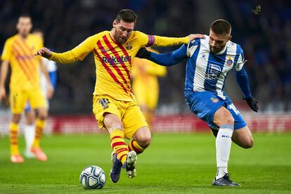 El delantero argentino del Barcelona, Leo Messi, regatea al jugador del Espanyol David Lopez, en un acción del partido.