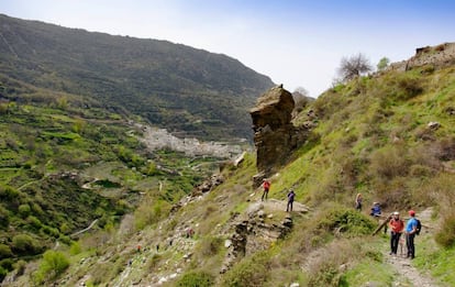 Hikers walk though the Poqueira gorge towards Pampaneira.