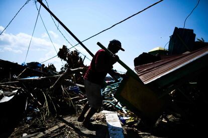 Un superviviente del terremoto rescata objetos entre los escombros de una mezquita en Wani (Indonesia).