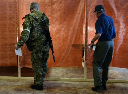 Um homem armado se prepara para votar a consulta, em Slavyansk.