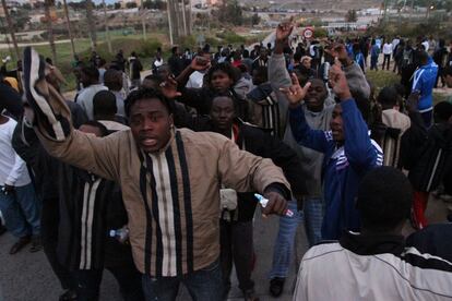 Inmigrantes del CETI de Melilla presencian el intento de salto a la valla de otros 'sin papeles'.