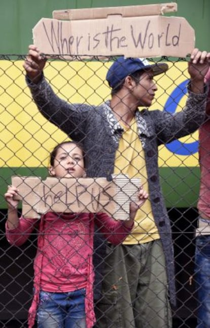 Refugees ask for help at Bicske station, 40 kilometers outside Budapest.