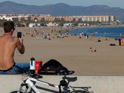 Una persona toma el lunes una imagen de la playa de la Malvarrosa en Valencia, que batió su récord de temperatura máxima para un mes de diciembre.