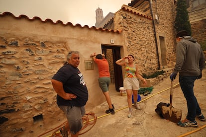 Varios vecinos de Añón de Moncayo, exhaustos el sábado tras luchar contra las llamas del incendio.