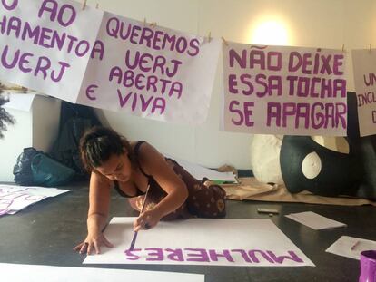 Aluna da UERJ confecciona cartazes de protesto na universidade.