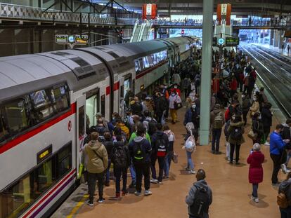 Dozens of people wait at a platform at Atocha train station in Madrid on Monday.