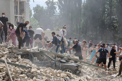 Rescue workers and volunteers search for survivors in the rubble of the Ohmatdyt children's hospital in kyiv on Monday.