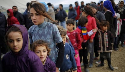 Refugees and migrants wait in line for tea in a camp in Idomeni, on the border between Greece and Macedonia.