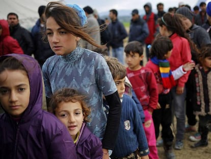 Refugees and migrants wait in line for tea in a camp in Idomeni, on the border between Greece and Macedonia.