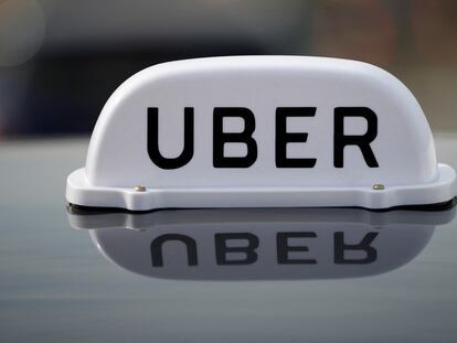 The Logo of taxi company Uber is seen on the roof of a private hire taxi in Liverpool, Britain, April 15, 2019.