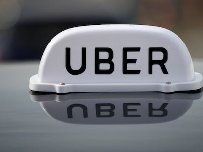 The Logo of taxi company Uber is seen on the roof of a private hire taxi in Liverpool, Britain, April 15, 2019.