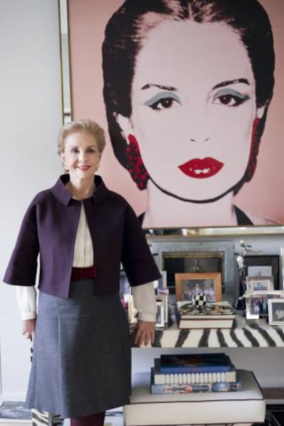 Carolina Herrera in front of Andy Warhol’s portrait that dominates her show room and which she paid for with a bejeweled clutch that Warhol had admired at a New York party.