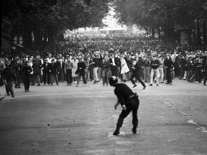 En el Bulevar Saint Germain de París un policía devueve un adoquín a los estudiantes durante el Mayo del 68 francés.