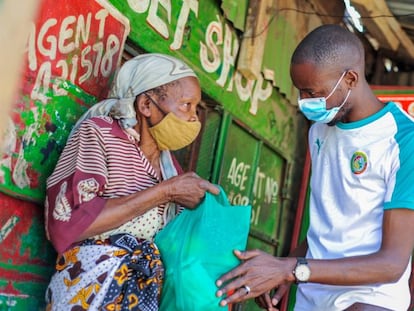 Una residente de Mathare recibe una bolsa con alimentos de Billian.