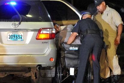 Noriega is taken away in a wheelchair after arriving at the airport in Panama.