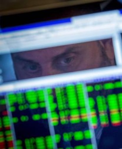 A specialist trader watches his screen on the floor of the New York Stock Exchange