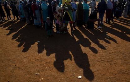 Afectados por el bloqueo económico causado por la crisis del coronavirus hacen cola para recibir alimentos, en Laudium, cerca de Pretoria (Sudáfrica).