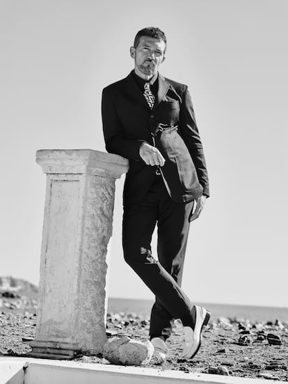 Antonio Banderas posing for ICON with a jacket by ALEXANDER MCQUEEN and a shirt and tie by VERSACE.