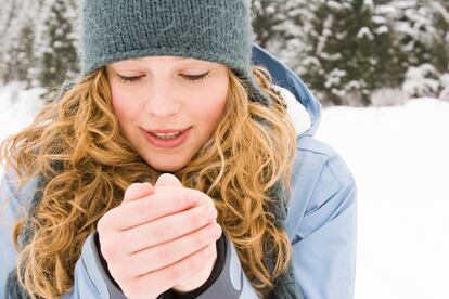 young woman warming up her hands.