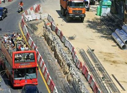 Los viajeros del bus turístico Madrid Visión recorren la calle de Serrano, levantada por las obras.