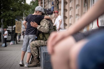 A boy hugs a Wagner mercenary in Rostov. 