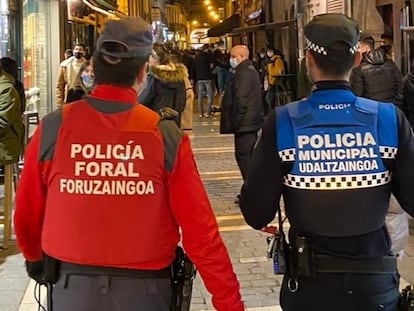 Un agente de la Policía Foral y otro de la Policía Municipal de Pamplona patrullan el pasado 14 de febrero por la capital navarra..
