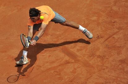 Rafael Nadal devuelve una pelota en posición forzada.