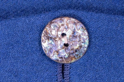Navy colored fabric with button texture background.