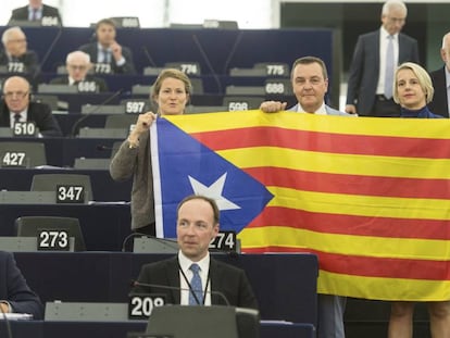 Members of the European Parliament pose with a Catalan secessionist flag during the debate