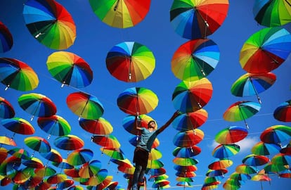 Un trabajador palestino de un café junto a la playa, decora su terraza con sombrillas coloridas como parte de las celebraciones del Ramadán en la ciudad de Gaza.