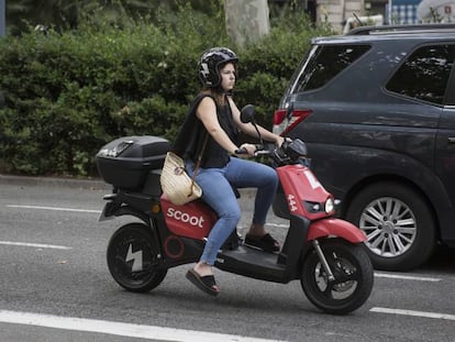 Una usuaria de una moto eléctrica compartida, en Barcelona.