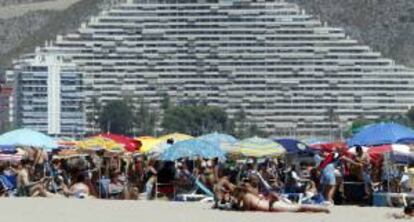 Veraneantes disfrutan al pie de los apartamentos de la playa de Cullera, en Valencia. EFE/Archivo