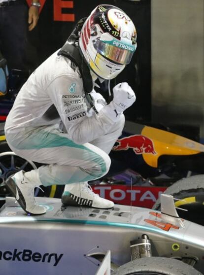 Mercedes driver Lewis Hamilton of Britain celebrates after winning the Singapore Formula One Grand Prix on the Marina Bay City Circuit in Singapore, Sunday, Sept. 21, 2014. (AP Photo/Wong Maye-E)