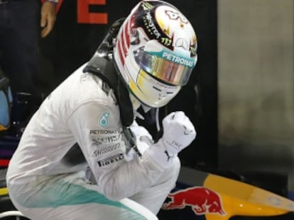 Mercedes driver Lewis Hamilton of Britain celebrates after winning the Singapore Formula One Grand Prix on the Marina Bay City Circuit in Singapore, Sunday, Sept. 21, 2014. (AP Photo/Wong Maye-E)