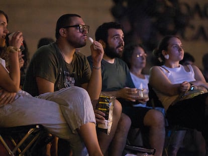 People eating during an open-air screening in Barcelona.