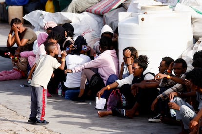 Migrants rescued at sea wait, after disembarking from a vessel, on the Sicilian island of Lampedusa, Italy, on September 18, 2023.