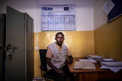 Mohamud Abdi Warsame, cooperante de Unicef, en el hospital Trocaire, en Dolow. En la pared, un cartel donde se apunta información de los ingresos.