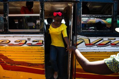 Una madre toma la mano de su hija mientras desembarca de un autobús enla comuna de Bourdon, en la capital haitiana de Puerto Príncipe, el 4 de abril de 2019.