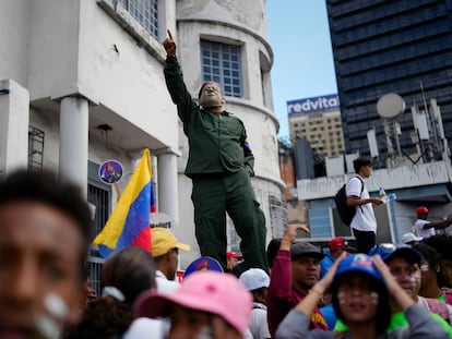 A pro-government supporter wears a mask of late Venezuela President Hugo Chavez during a march in Caracas, Venezuela, on February 12, 2023.