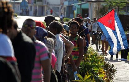 Decenas de personas se reúnen cerca a la entrada del cementerio Santa Ifigenia, en Santiago de Cuba, (Cuba) donde ya descansan desde hoy, domingo 4 de diciembre de 2016, las cenizas del líder de la revolución cubana Fidel Castro, esperando a que sea abierto el acceso al público para visitar su tumba.