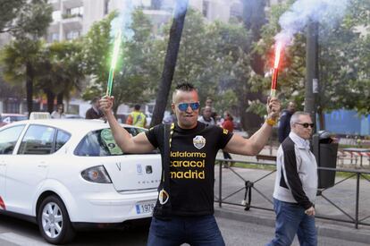 La Federación Profesional del Taxi y Elite Taxi Madrid han convocado hoy una manifestación para solicitar a la Consejería de Transportes de la Comunidad y al Ministerio de Fomento medidas de apoyo al sector del taxi. En la imagen, un taxista con dos bengalas durante la manifestación celebrada hoy en la madrileña calle Raimundo Fernández Villaverde.