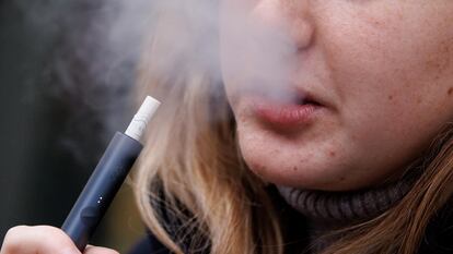 A teenager vapes in London in March.