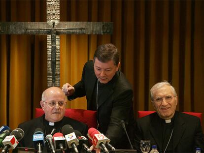 Martínez Camino prepara los micrófonos a Blázquez mientras sonríe Rouco Varela, en la apertura de la asamblea de los obispos de esta semana.