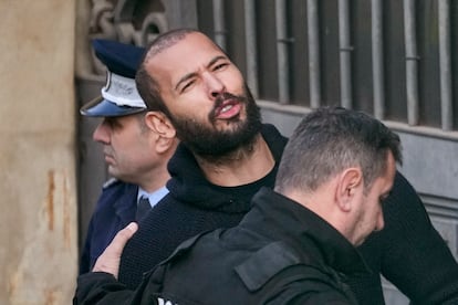 Police officers escort Andrew Tate to the Court of Appeal in Bucharest, Romania, on February 1, 2023.
