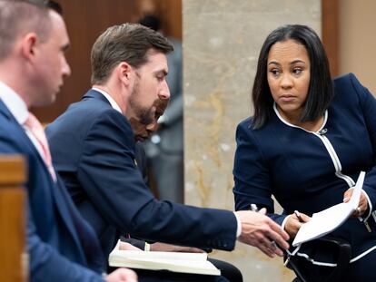 Fani Willis, the Fulton County district attorney prosecuting the case against Trump in Georgia, with two associates in May 2022.